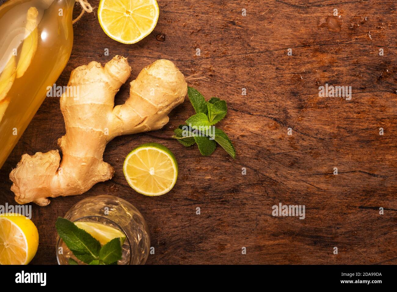 Ginger Ale Cocktail with Beer, Lime, Lemon and Mint in glaass on wooden