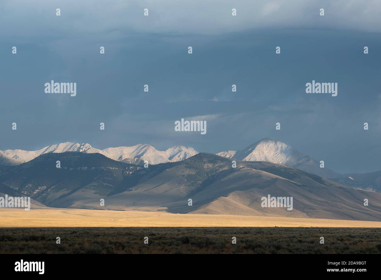 Morning sunlight shines on the southern Lemhi Range, including Diamond Peak (right), in Idaho. Stock Photo