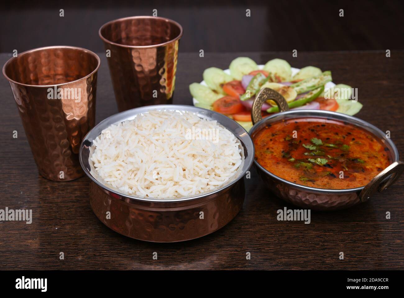 Traditional Rajasthan food thali Jaipur, India. White rice, missi , jowar roti side dish dal fry, gatta masala, baati ball, raita, churma sweet lassi Stock Photo