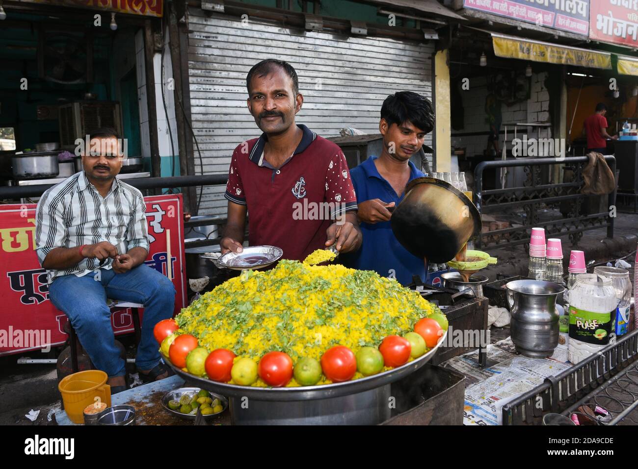 Jaipur, India. May 10, 2017. Indian man selling street food Poha or onion pohe popular traditional Indian food breakfast dish, snack beaten rice flake Stock Photo
