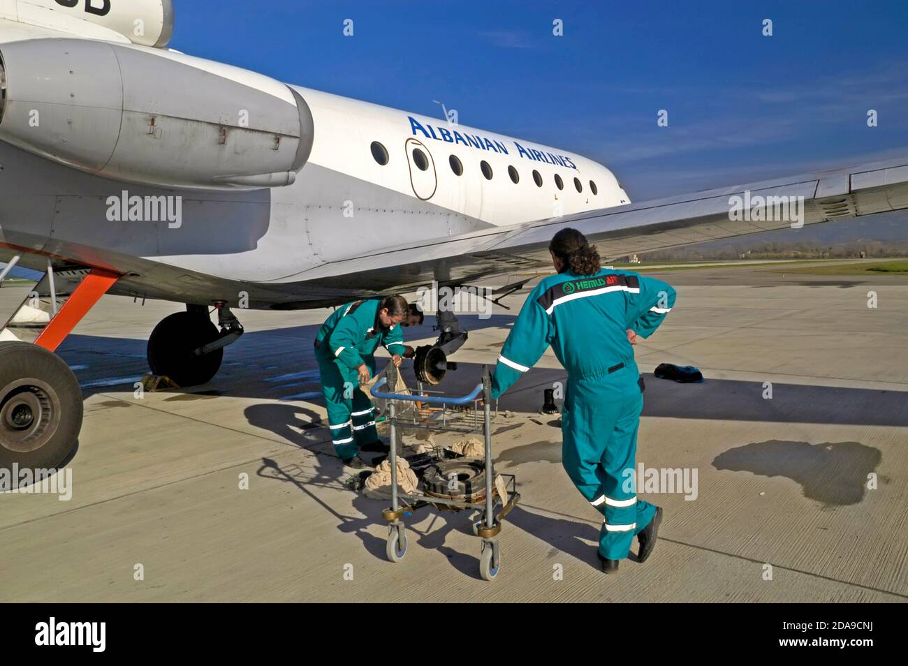 Mechanics repairing an aeroplane on the runway at Mother Theresa international airport, Tirana, Albania Stock Photo