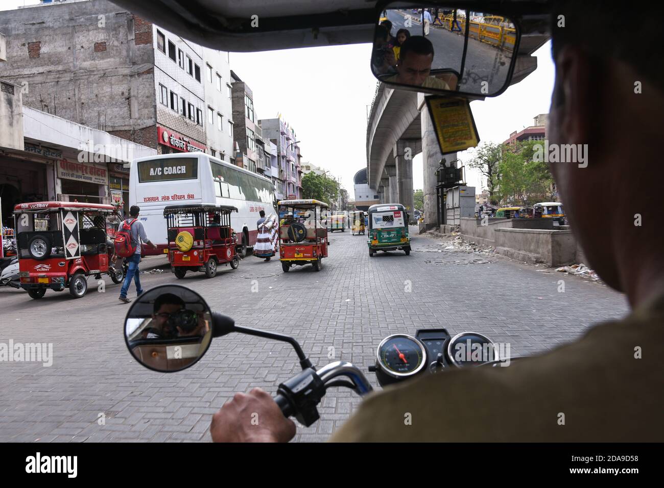 Tourists in Jaipur city during Tuk-Tuk safari on the busy Indian roads on Rajasthan, North India. Stock Photo