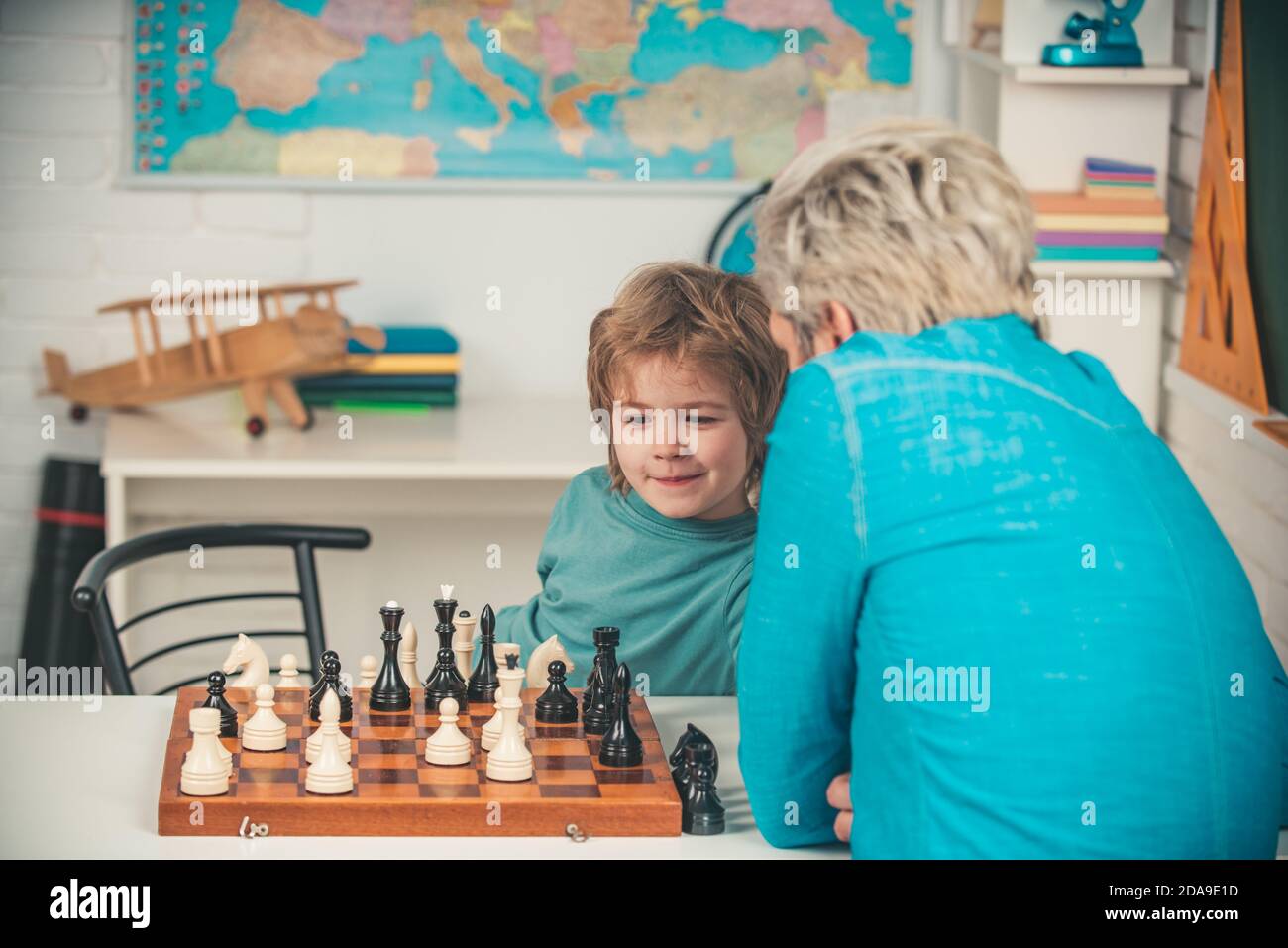 Boy kid playing chess at home. Games and activities for children. Family concept. Stock Photo