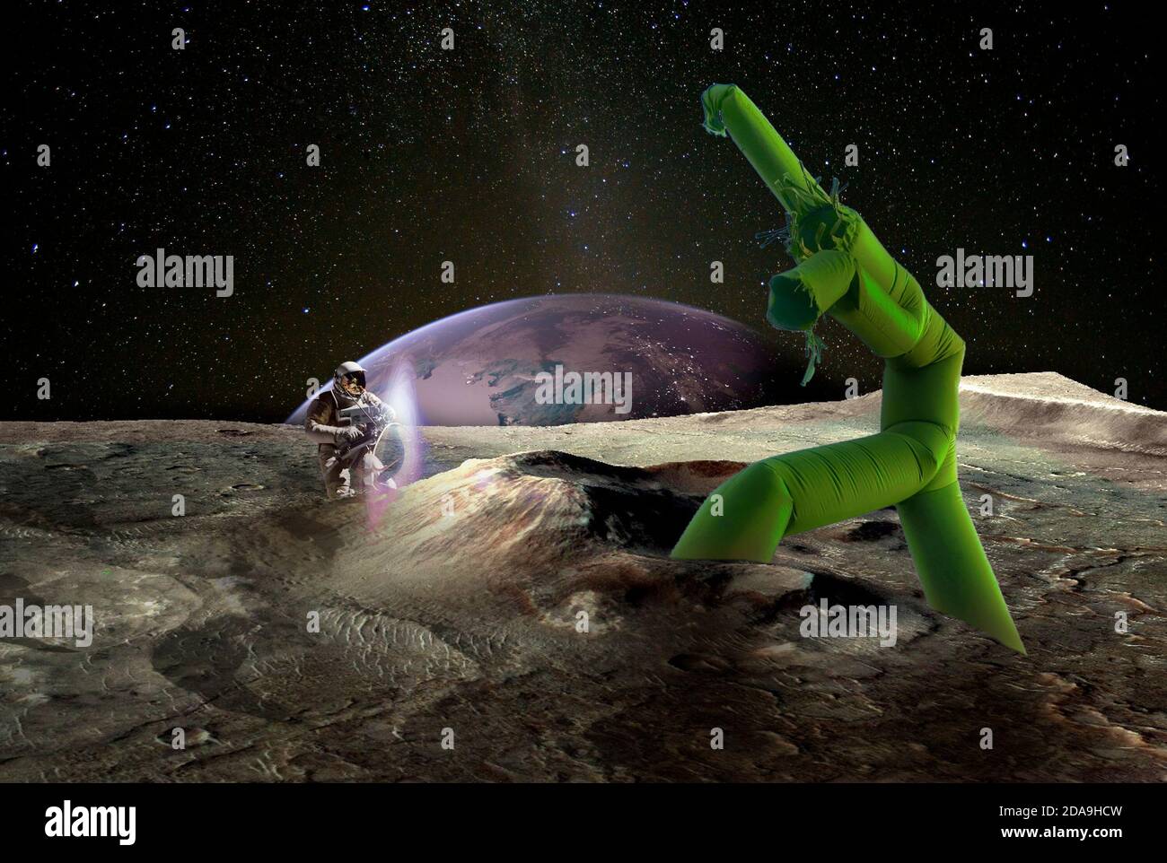 The battle for the Earth. Moon surface, planet Earth in the distance. Caricatured green alien fights against the human cosmonaut. Elements of this ima Stock Photo