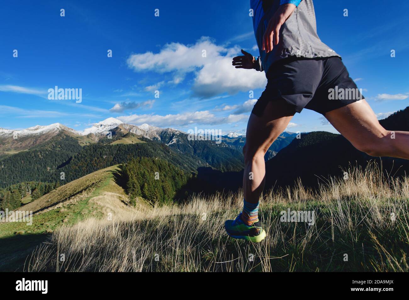 Detail of mountain runner legs during a downhill workout Stock Photo
