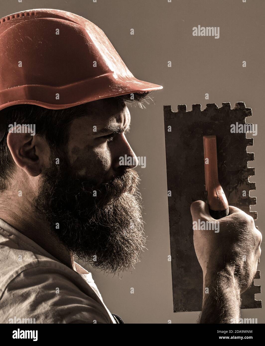 Mason plastering concrete to build. Plastering tools. Tool, trowel