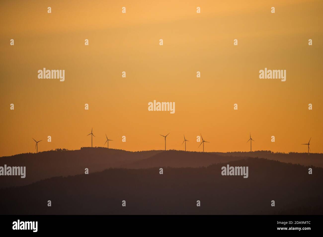Wind power stations - wind turbines on the horizon, in the mountains, sky Stock Photo