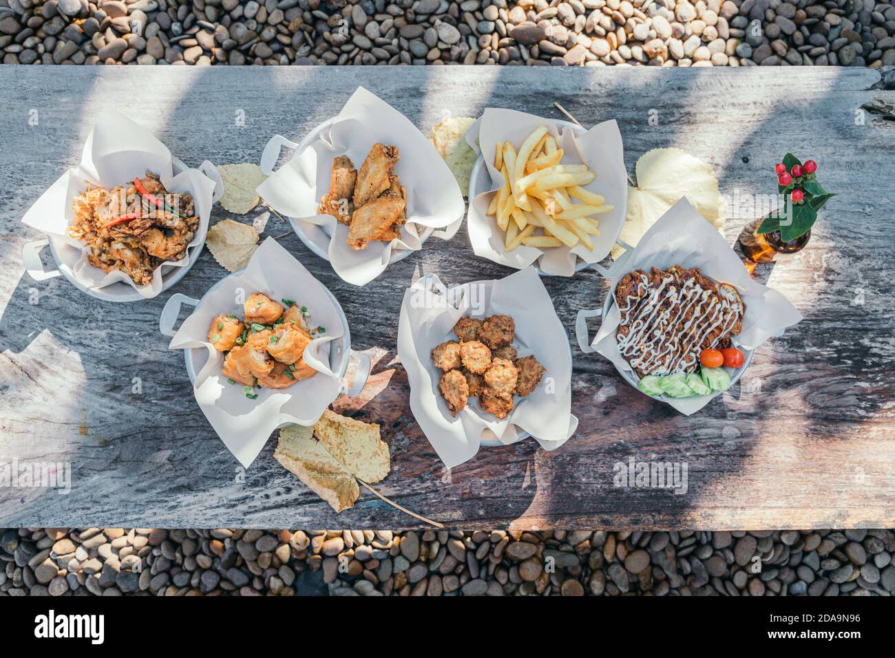 Top view deep-fried food party on outdoor wooden table wit stone ground background Stock Photo