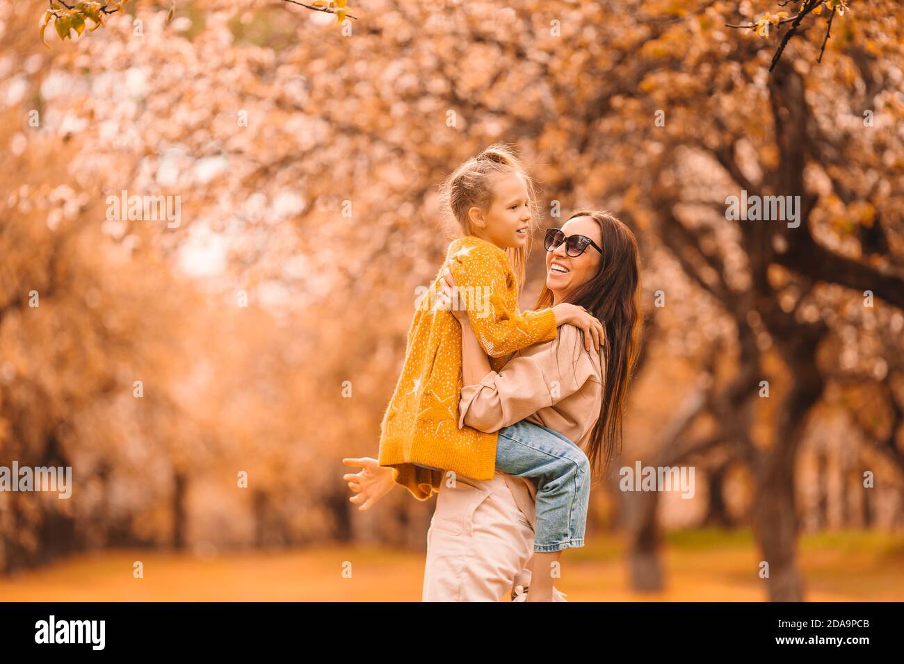 Little girl with mom outdoors in park at autumn day Stock Photo - Alamy