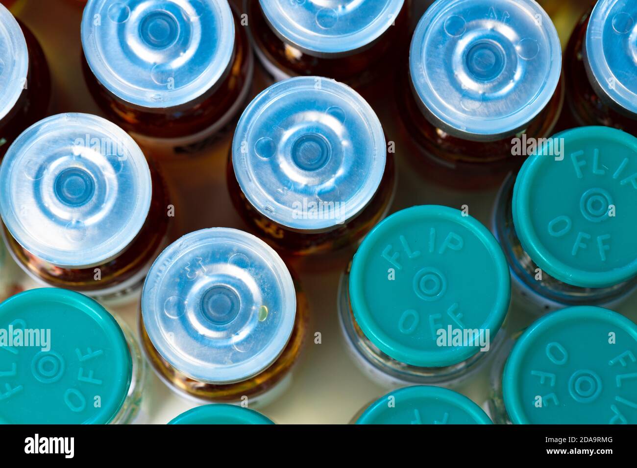 Pile of glass medical vials with medication on lab table Stock Photo
