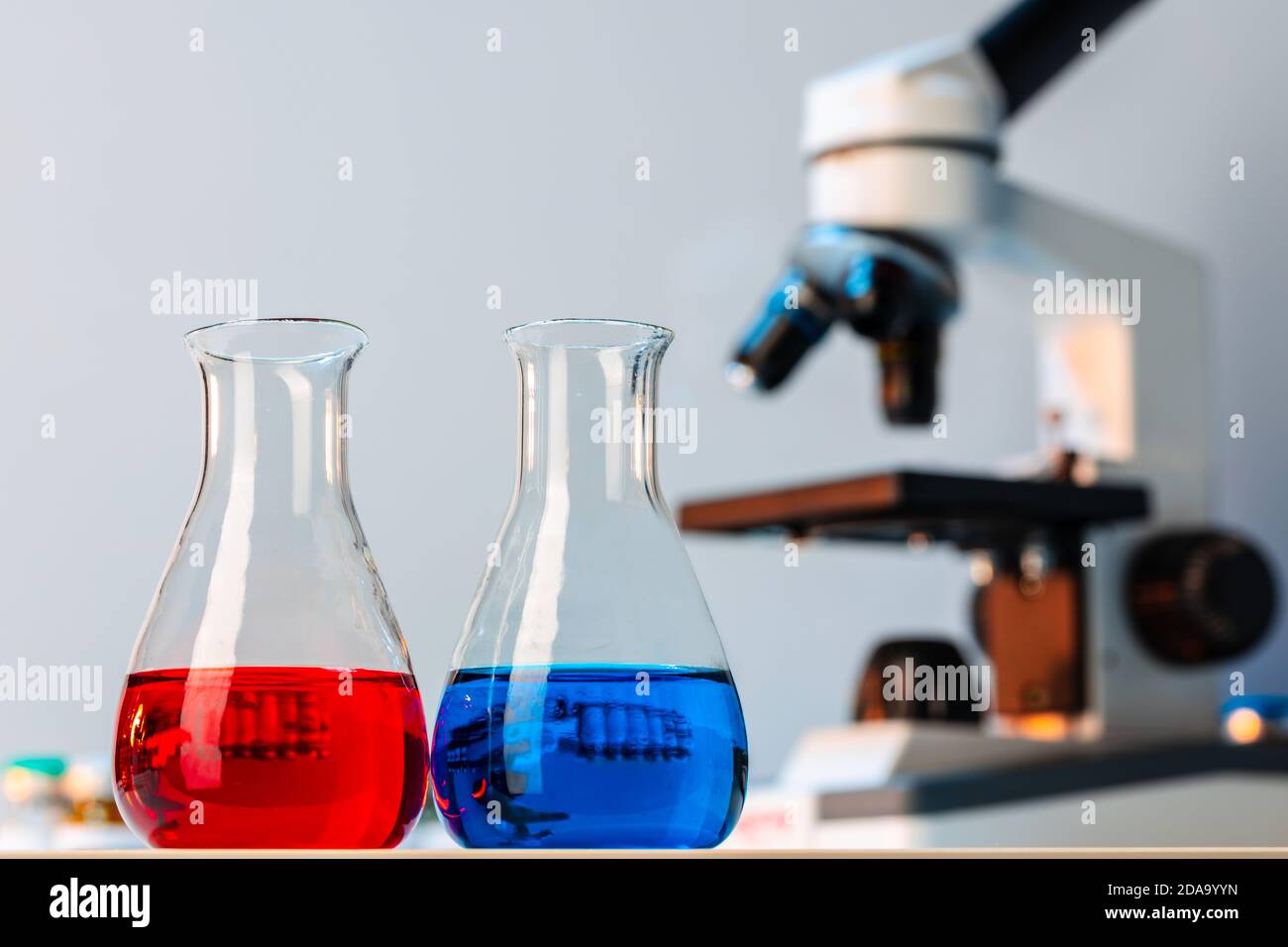 Medical vial with medication near microscope photo Stock Photo - Alamy