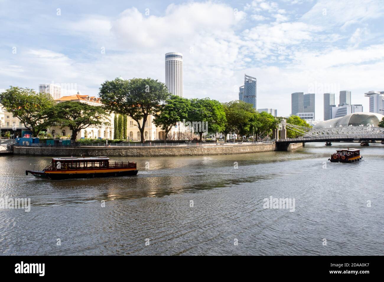 Singapore, 21/01/19. Singapore River with Cavenagh Bridge, only suspension bridge, tourist boast, trees on the river bank, Asian Civilisations Museum Stock Photo