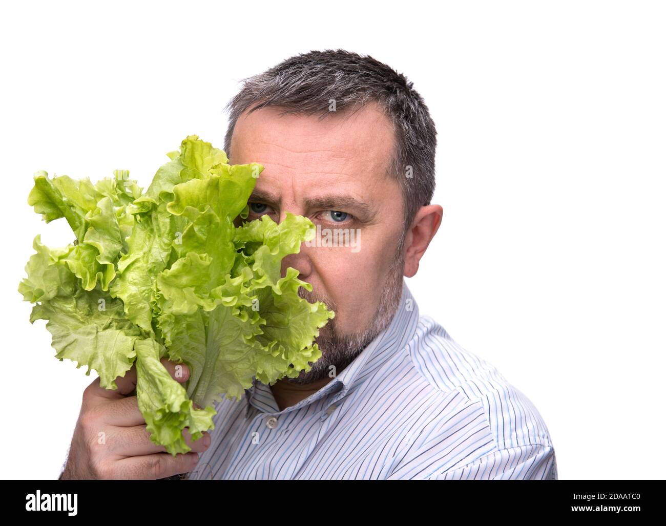 Organic food. Man holding lettuce isolated on white Stock Photo