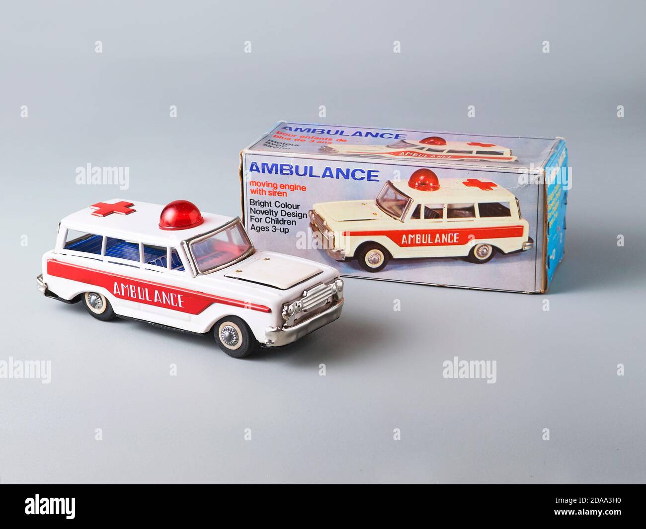 A classic tin toy ambulance van with an vintage box on the back Stock Photo