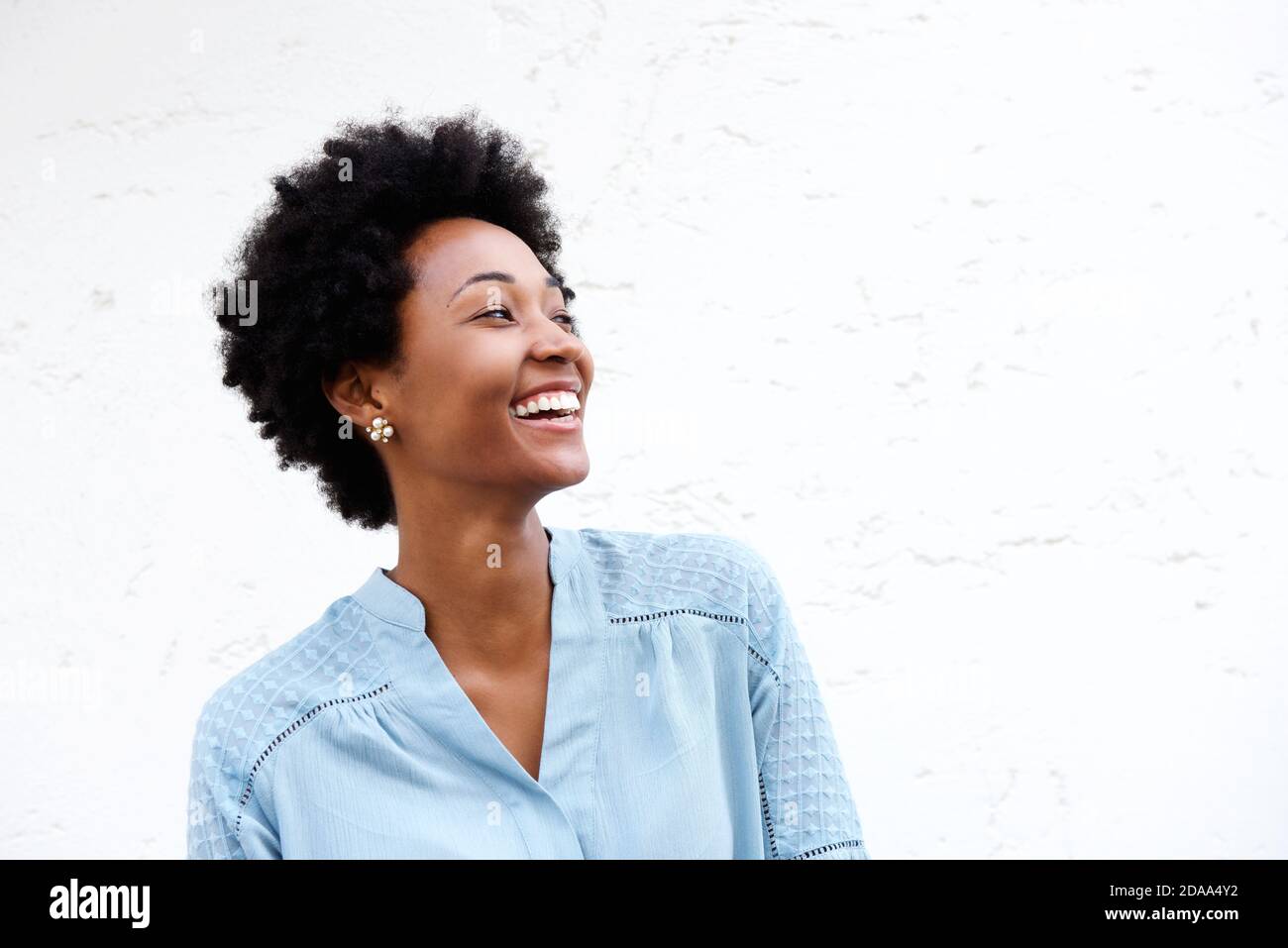 Close up portrait of beautiful young black woman looking away and ...