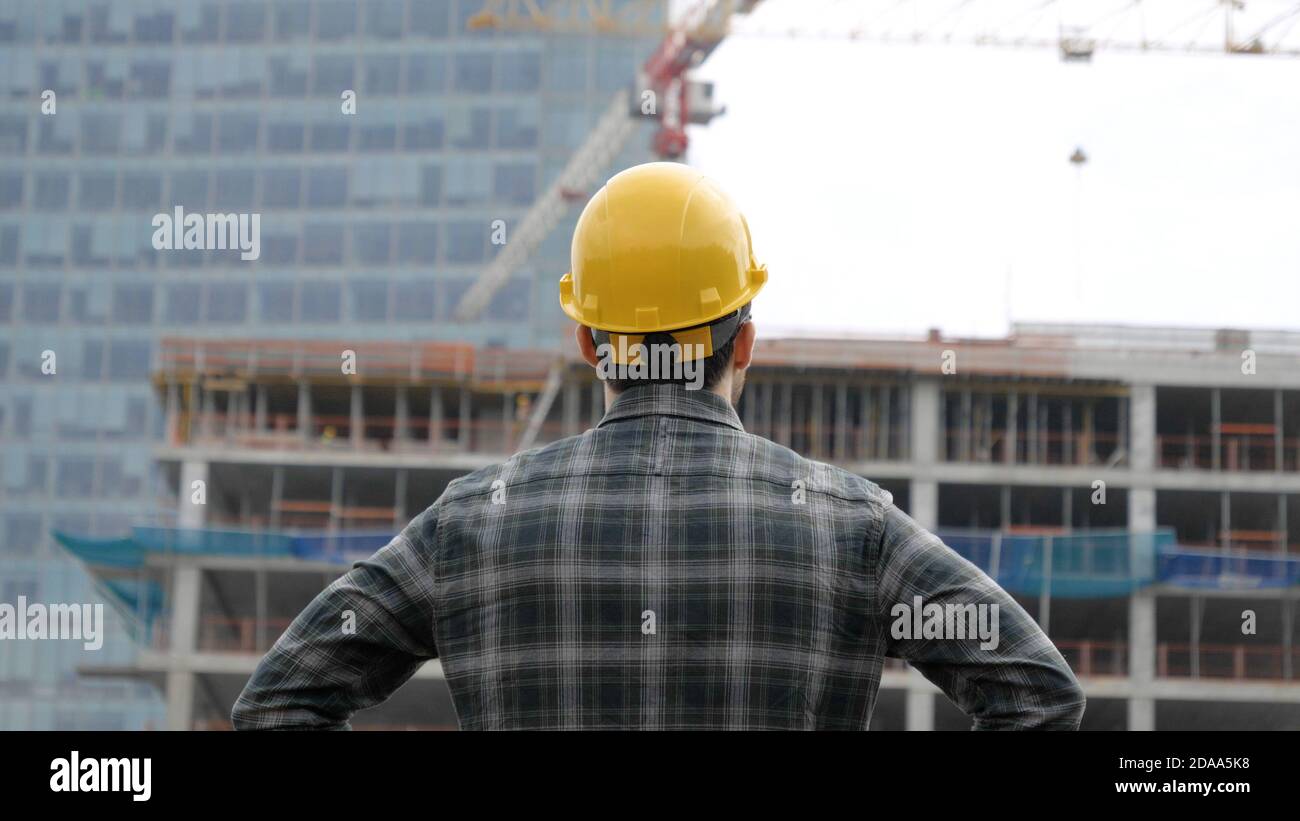 Young engineer looking at construction works. Stock Photo