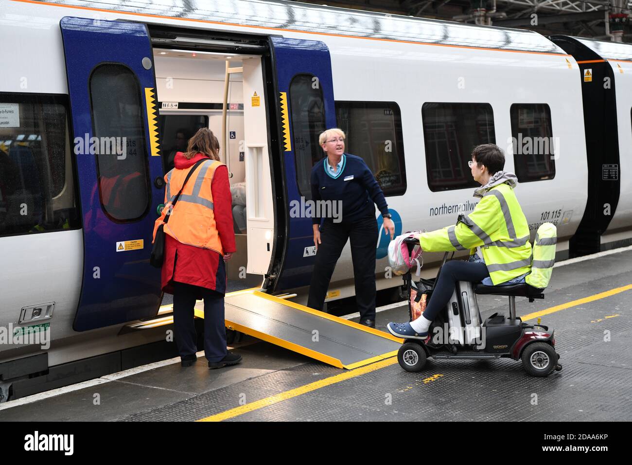 Staff helping disabled passenger hires stock photography and images