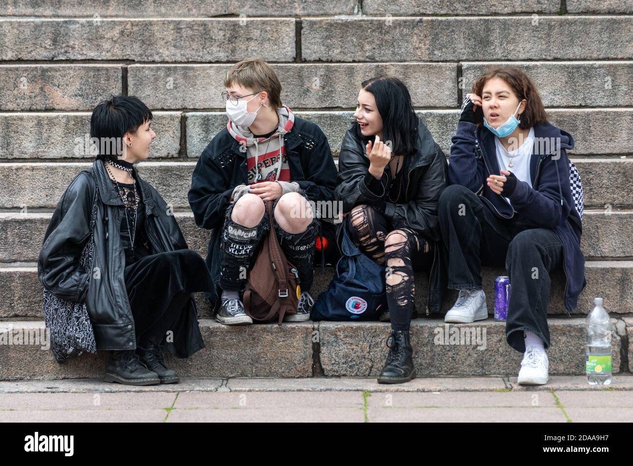 Young women sitting on Helsinki Cathedral stairs in Senate Square, Helsinki, Finland Stock Photo