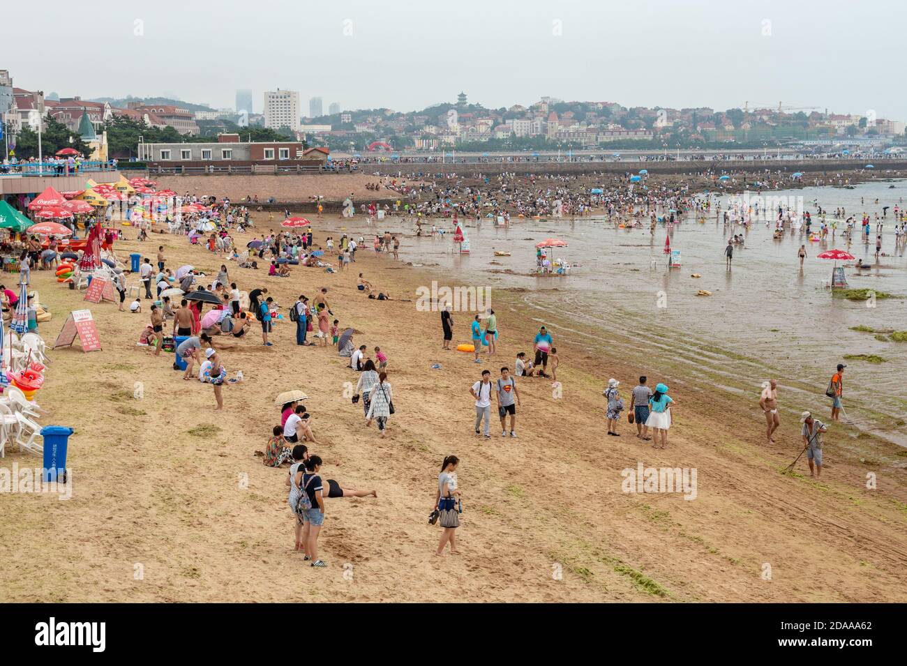 Qingdao / China - August 5, 2015: People bathing at the Qingdao city beach, Shandong province, China Stock Photo