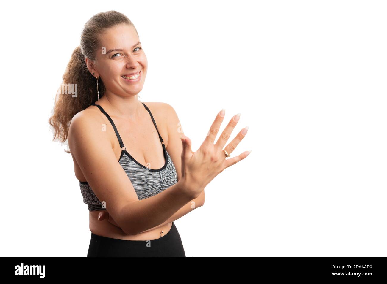 Smiling woman making number five or 