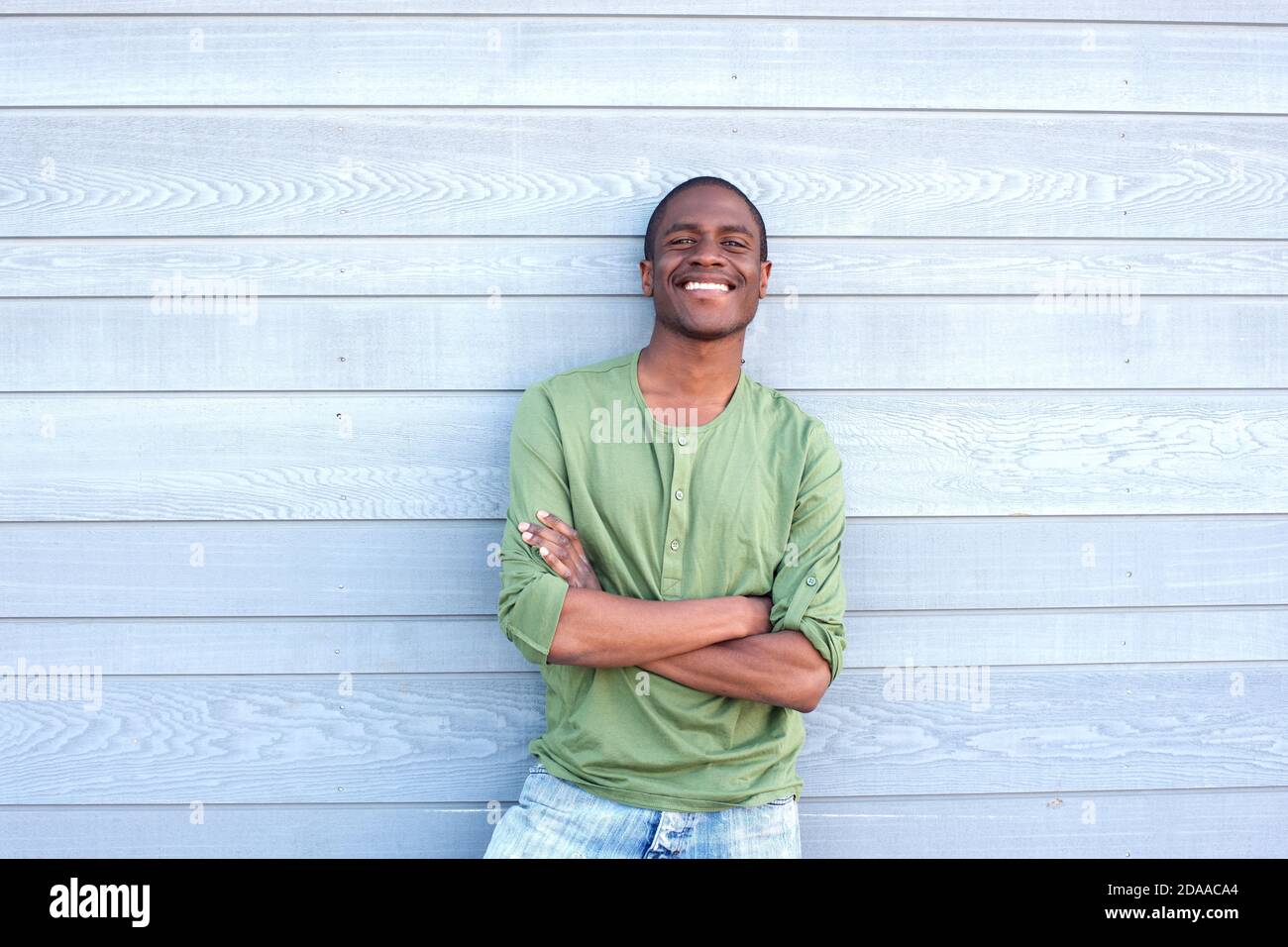 Portrait of a confident young black man smiling with arms crossed Stock ...