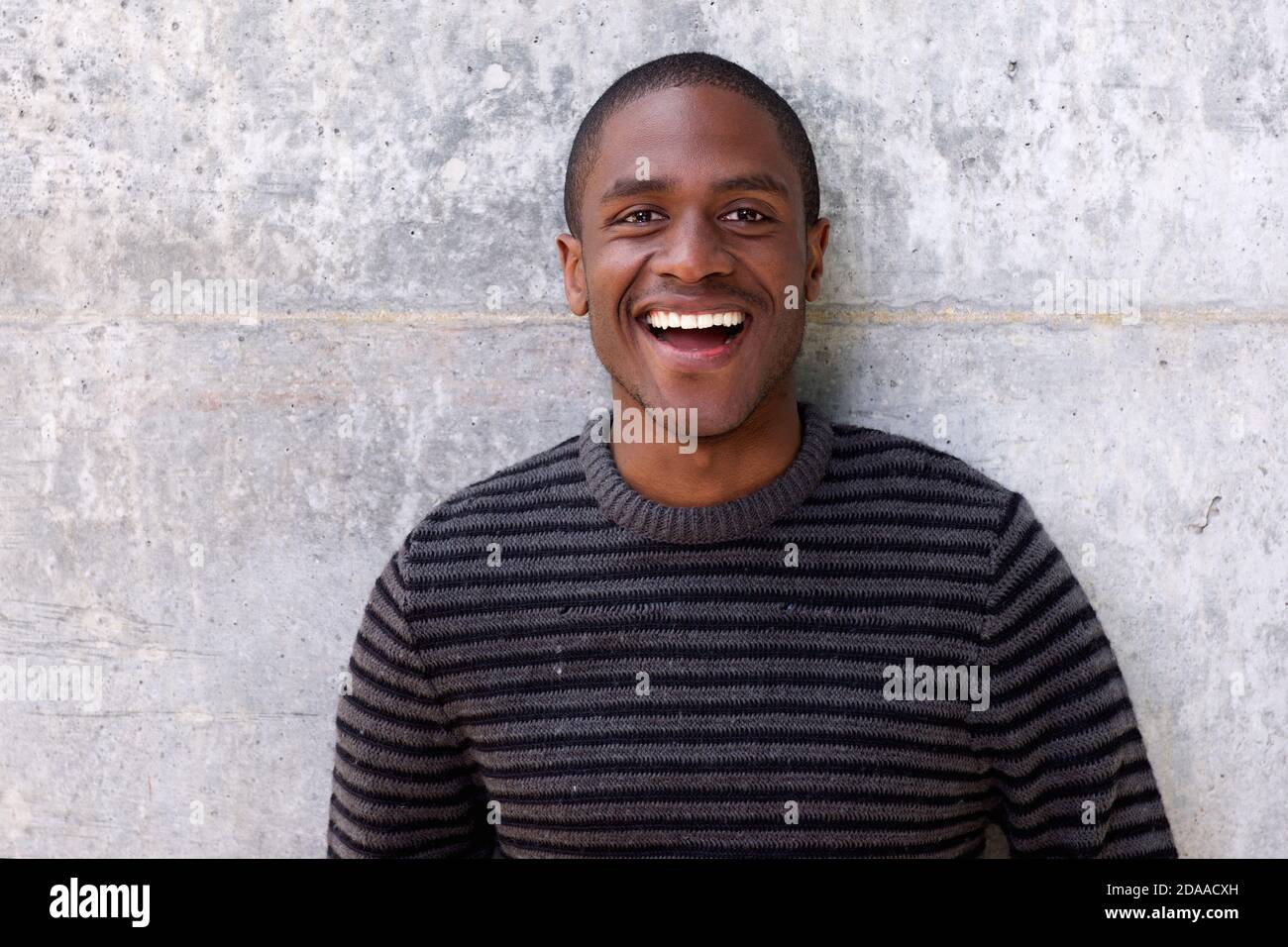 Portrait of handsome young african american man laughing Stock Photo