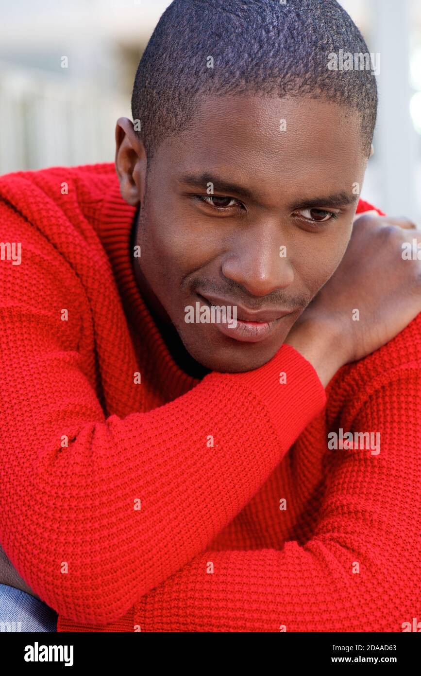 Young afro american man sitting hi-res stock photography and images - Alamy