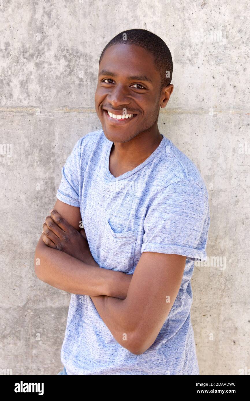 Portrait of smiling black guy with arms crossed Stock Photo Alamy