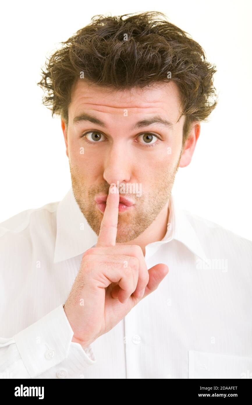 Man puts his finger on his mouth hires stock photography and images