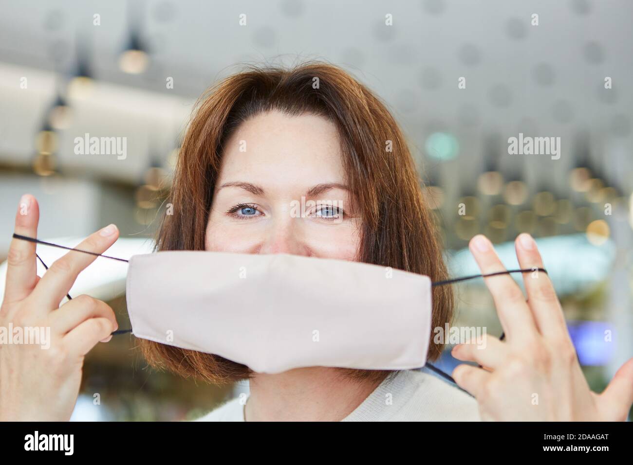Woman gives instructions on how to properly put on a mask as protection