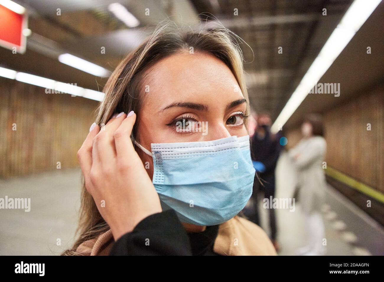 Woman as a passenger or commuter with a face mask because of the Covid
