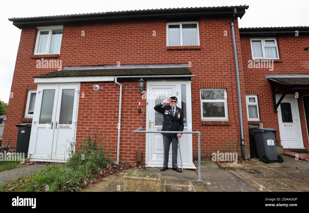 Bournemouth, UK. 11th November 2020.  David Comer, 90, a  Royal Army Service Corps veteran of the Suez Crisis , stands on  the doorstep of his home in Bournemouth, Dorset, to observe two minutes silence on Armistice Day.  credit: Richard Crease/Alamy Live News Stock Photo