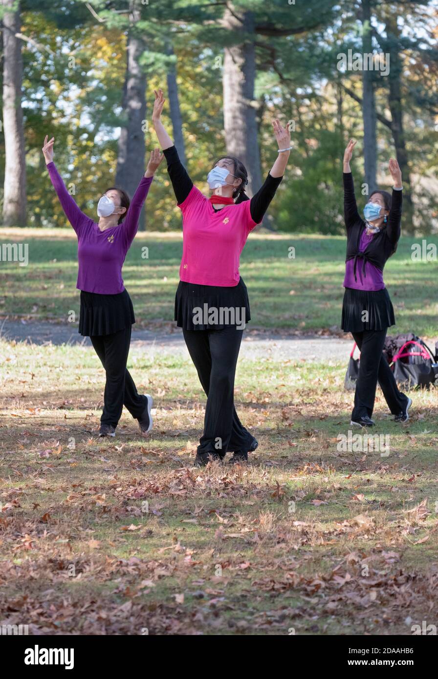 Asian American women masked and distancing at a dance exercise class in Kissena Park, Flushing, Queens, New York City. Stock Photo