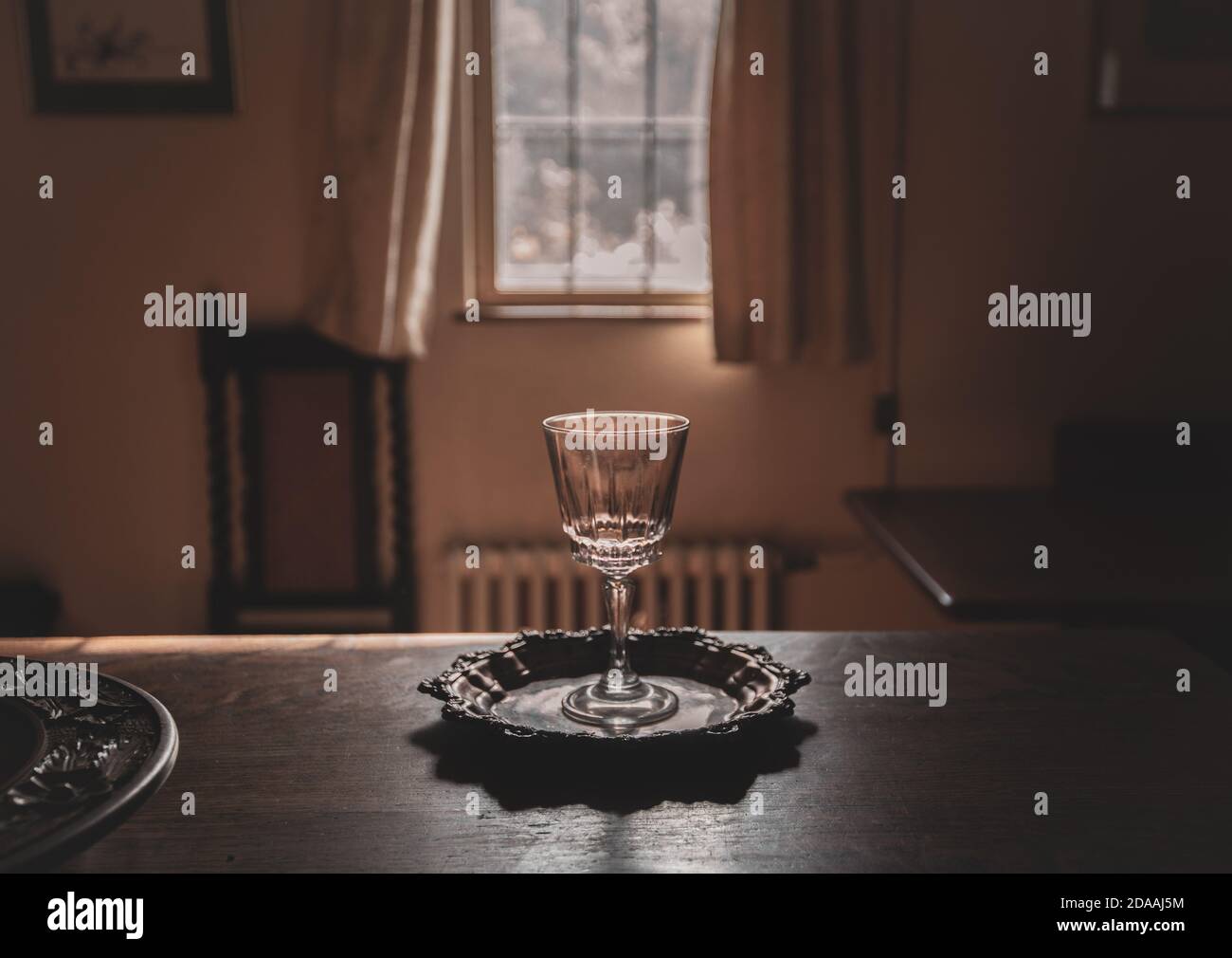 Wine glass on a silver platter in a house interior Stock Photo