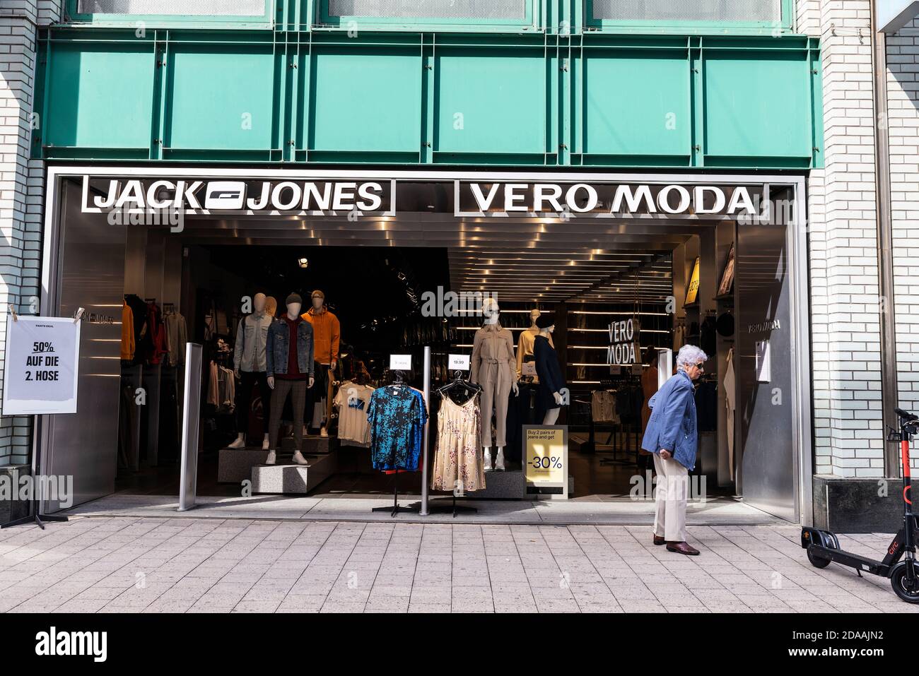 Hamburg, Germany - August 23, 2019: Facade of a Jack and Jones clothing store with a senior woman around in Spitalerstraße, shopping street in Altstad Stock Photo
