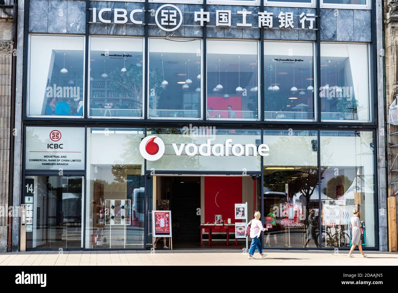 Hamburg, Germany - August 23, 2019: Vodafone shop and ICBC bank office with people around in Jungfernstieg, an urban promenade in Hamburg, Germany Stock Photo