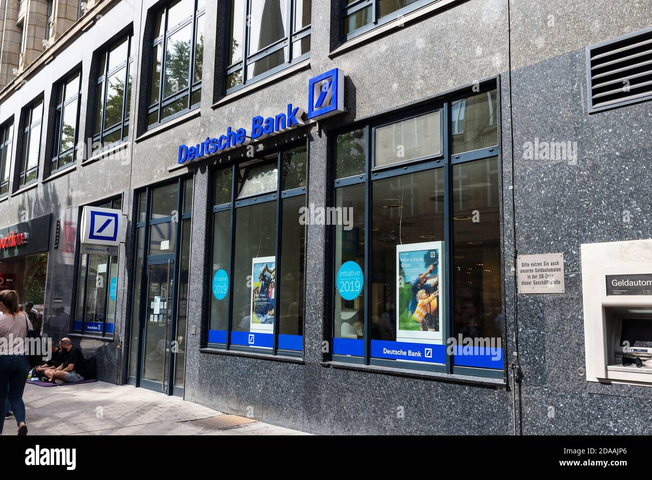 Hamburg, Germany - August 23, 2019: Facade of a Deutsche Bank branch office with people around in Spitalerstraße, shopping street in Altstadt quarter, Stock Photo