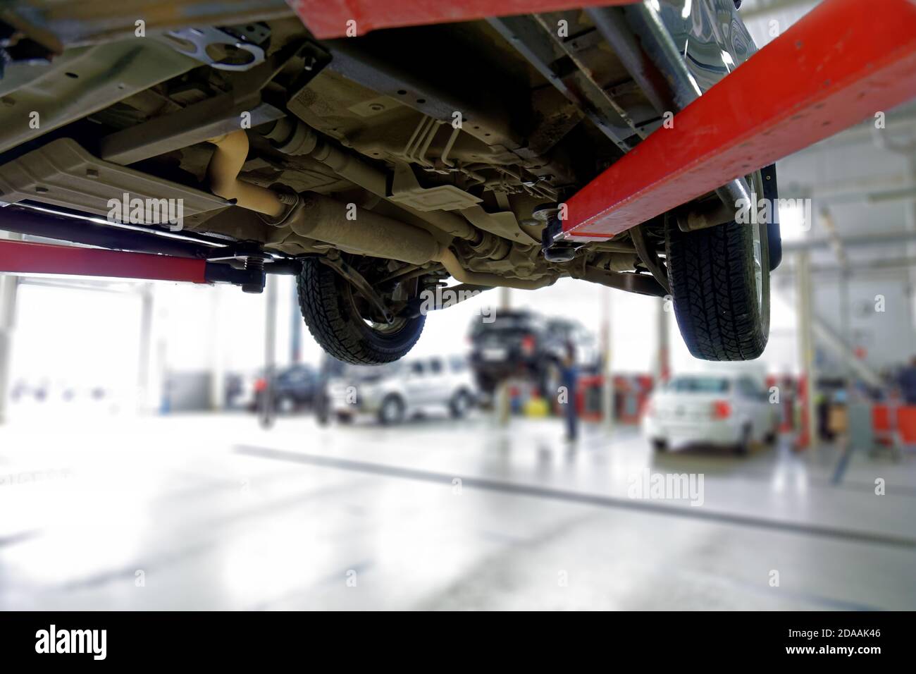 Car on the lift in the service center. Blurred background. Stock Photo