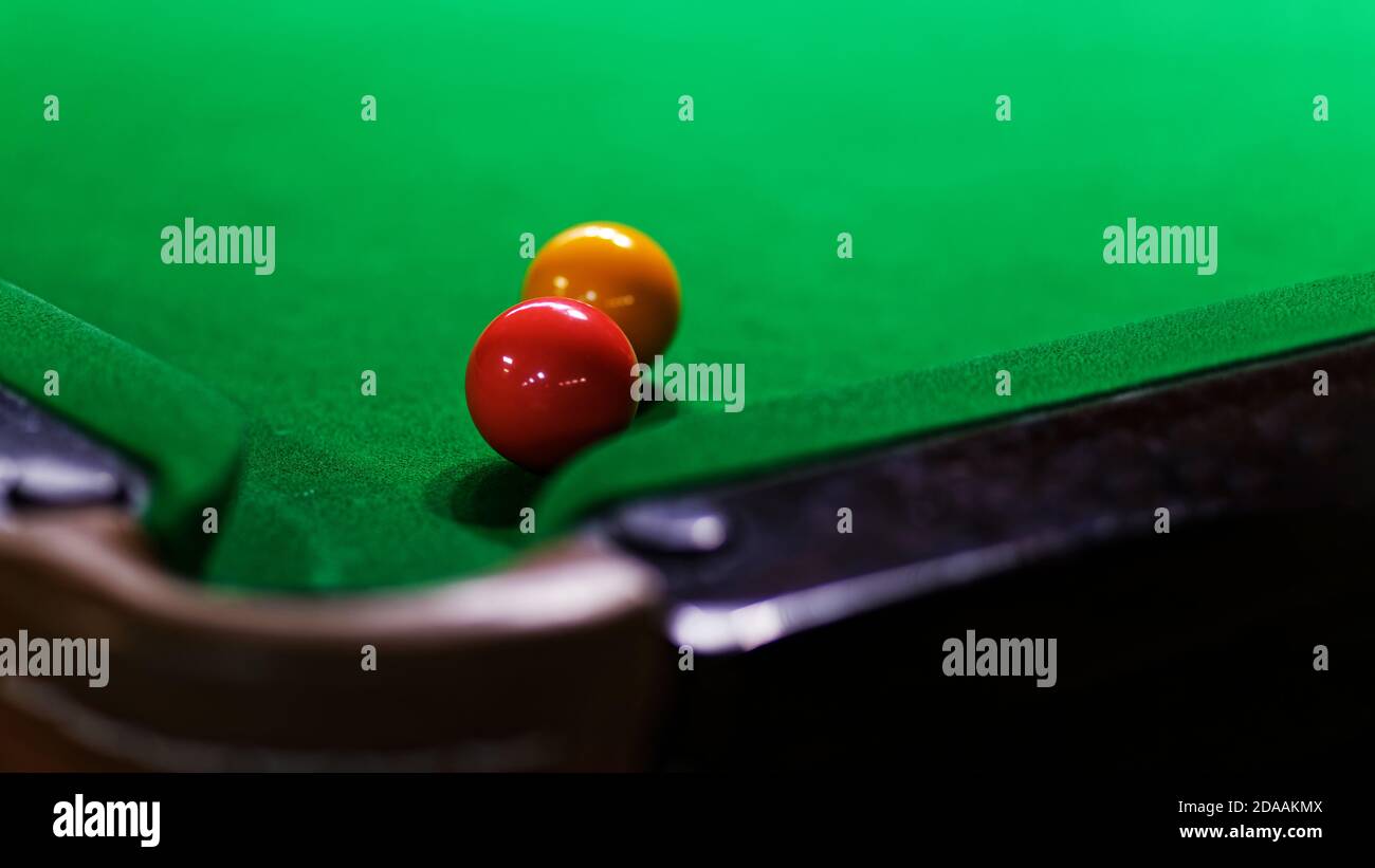 Two billiards balls on green billiards table. Shallow focus. Copyspace