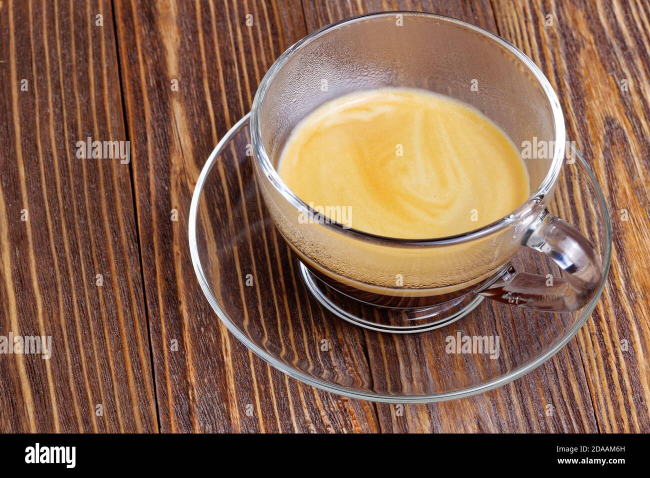 Transparent cup with espresso on wooden table Stock Photo