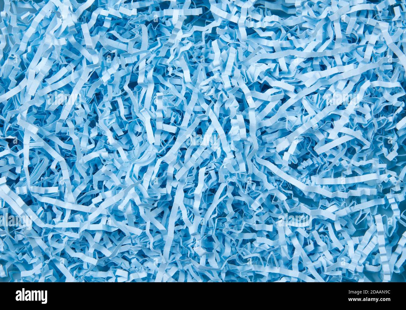 Blue color shredded paper - gift box filler background. Stock Photo