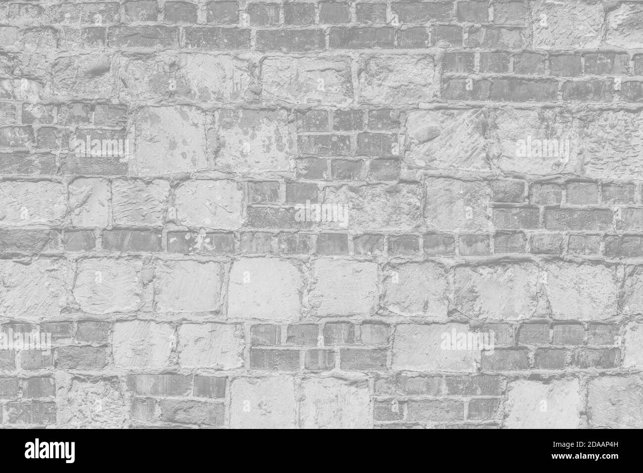 Abstract light gray background. Vintage bricklaying structure. Uneven painted plaster in whiten facade background. Stock Photo