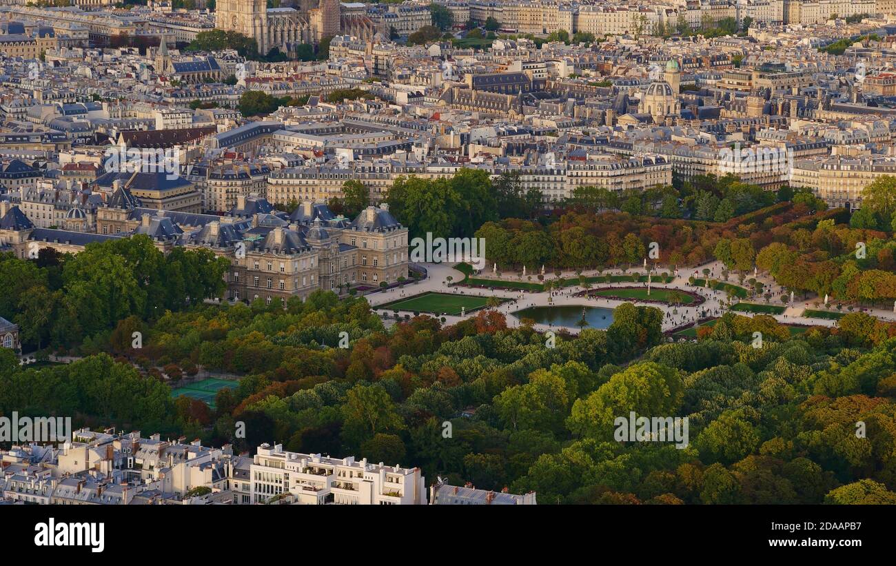 Beautiful aerial panorama view of famous park area Jardin du Luxembourg with historic Luxembourg Palace and discolored trees in early autumn. Stock Photo