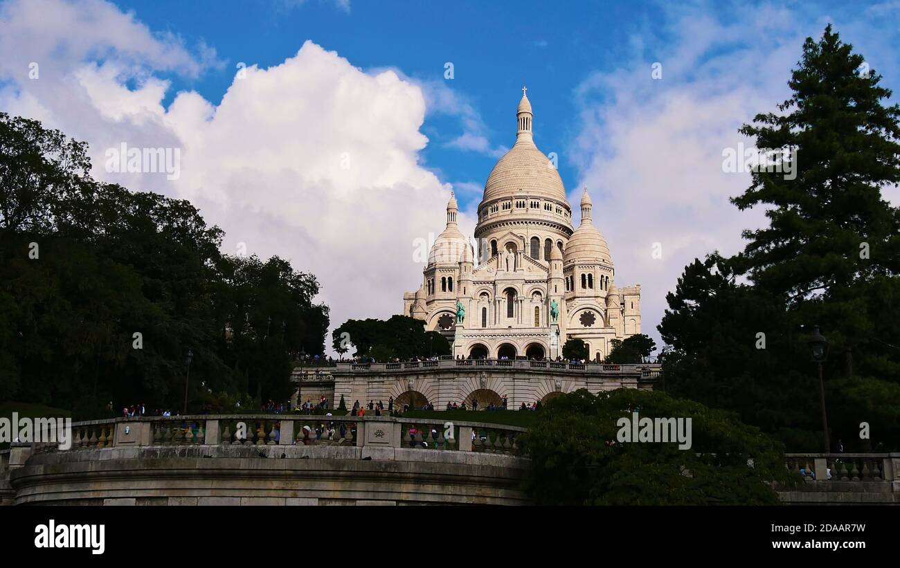 Spectacular Basilica of the Sacred Heart (Sacre-Coeur Basilica) of Paris, France located on Montmartre hill, a popular tourist destination. Stock Photo