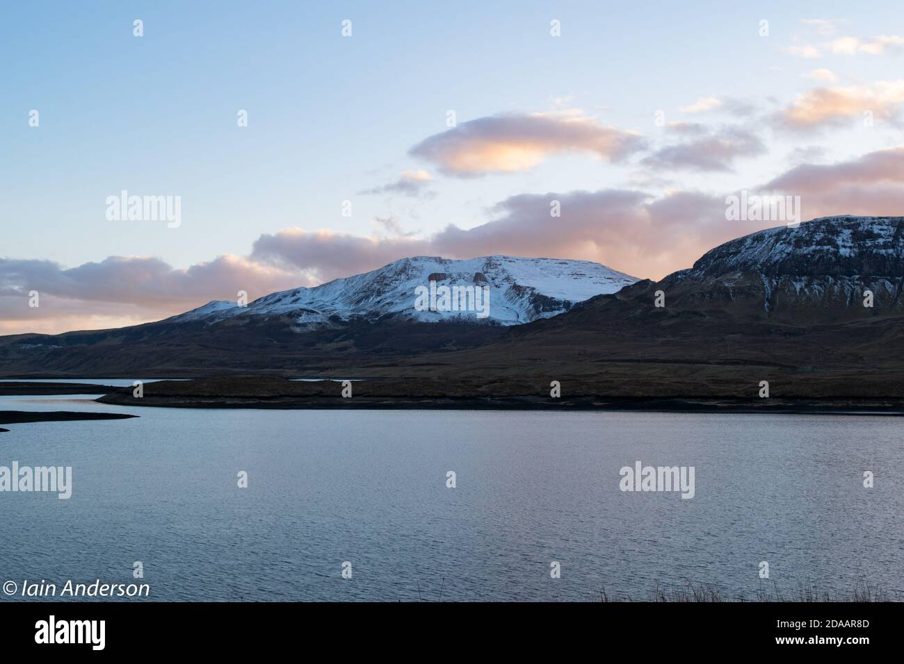 A view over Loch Leathan in Skye toward the islands stunning snow capped mountains. Stock Photo