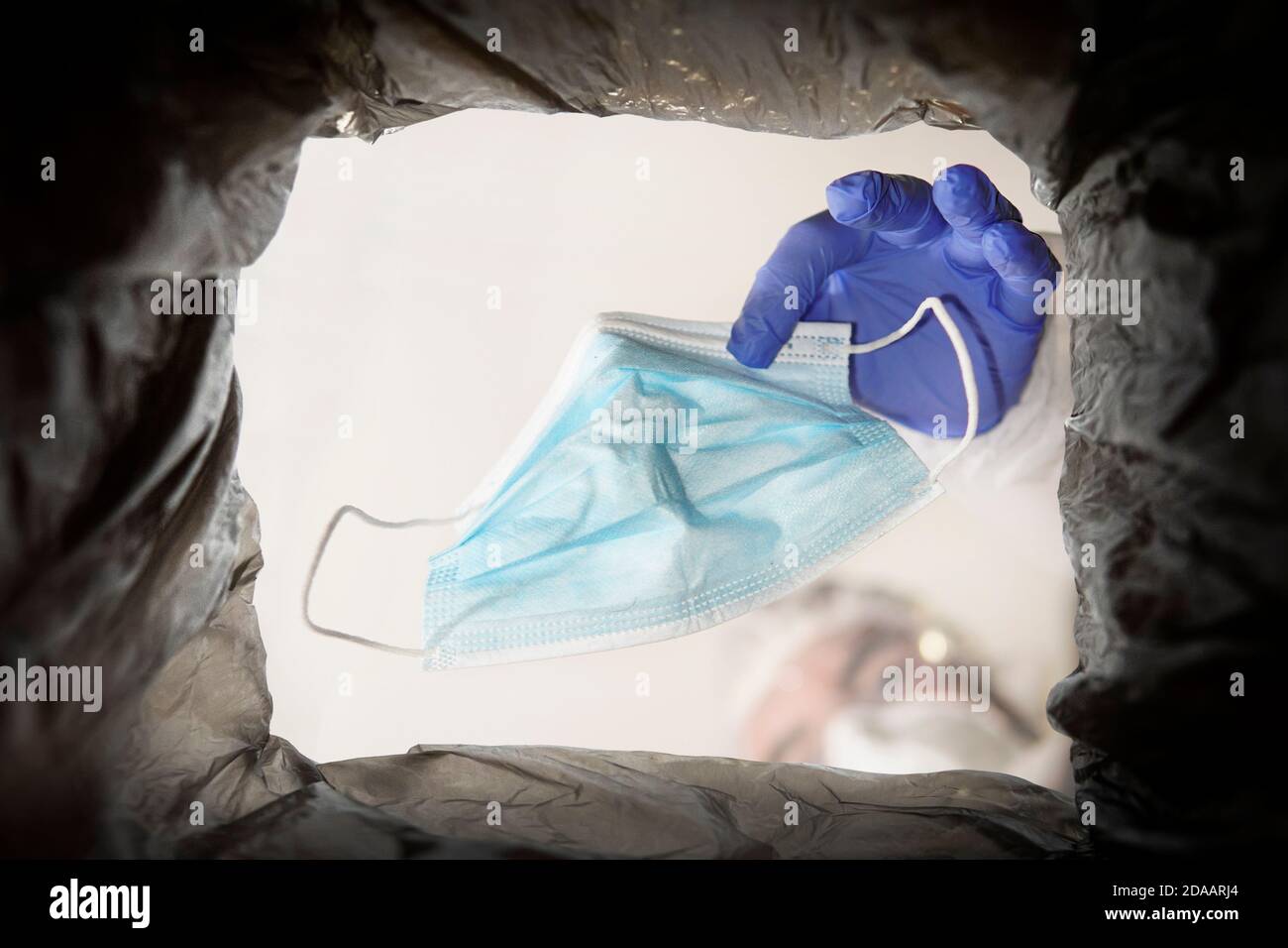 Throwing away single use medical face mask. Face mask after use