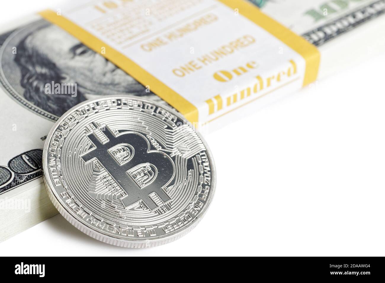 Coin bitcoin and bank bundle of 100 dollars. Concept of international  virtual cryptocurrency, finances and management. Isolated on white. Shallow  focu Stock Photo - Alamy