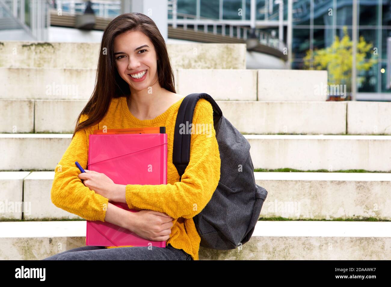 Portrait of smiling female student holding notebook and pen Stock Photo ...
