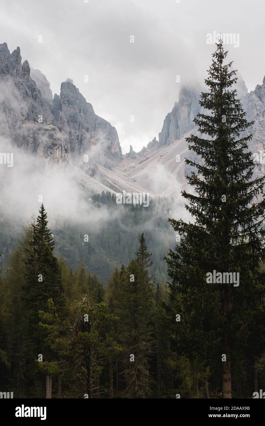 Mysterious cloudy mountains appear from the mist in the Italian alps Stock Photo