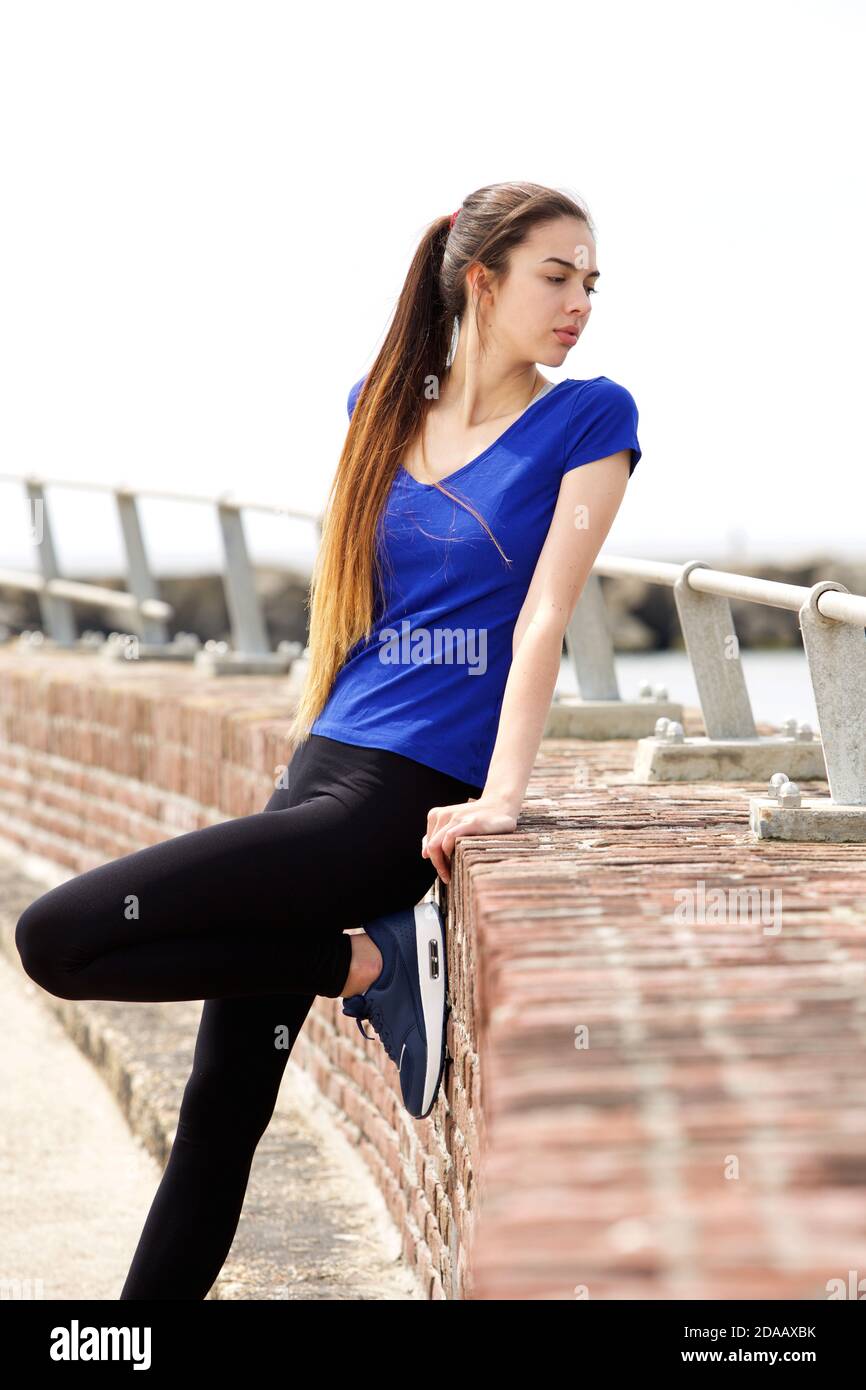 Portrait of attractive sporty woman looking over shoulder Stock Photo